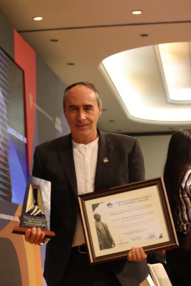Trabajador académico con su reconocimiento.